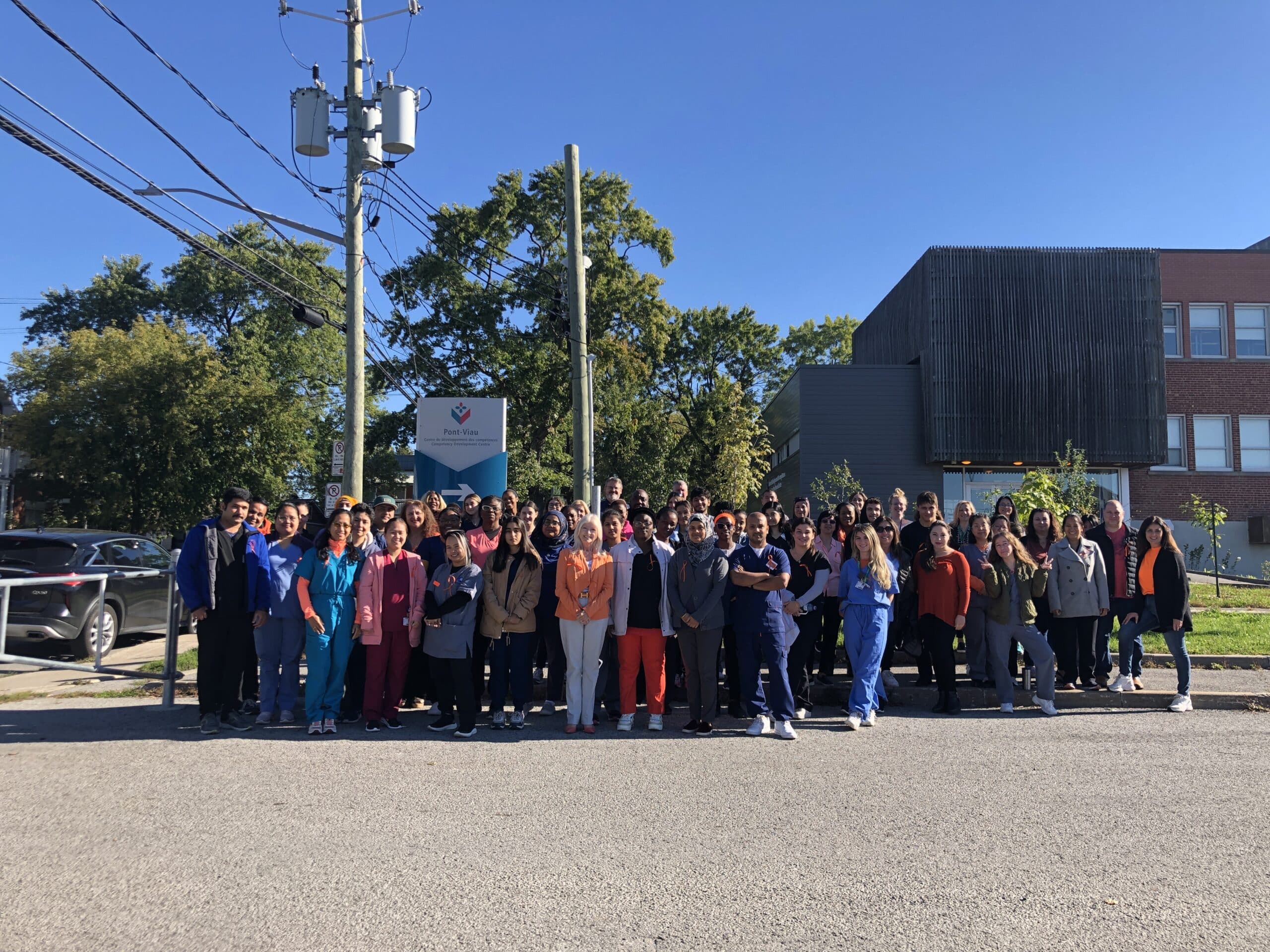 Group of international and local students in front of CDC Pont-Viau vocational training centre in Laval.